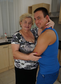 Curvy granny having fun with her toy boy in the kitchen