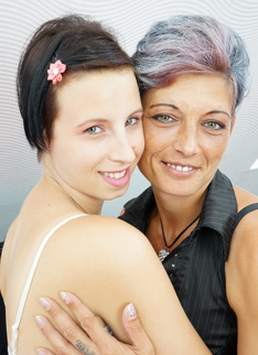 Old and young lesbian couple make out on the couch