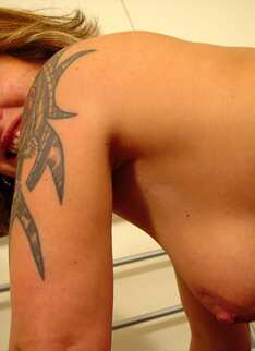 Hot Mature Chick Showing Off Tattooed Body