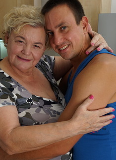 Curvy granny having fun with her toy boy in the kitchen