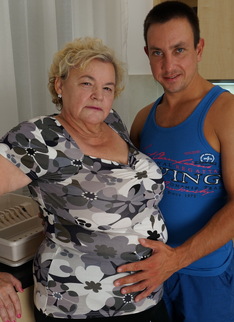 Curvy granny having fun with her toy boy in the kitchen