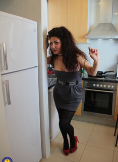 Naughty Spanish housewife playing in her kitchen