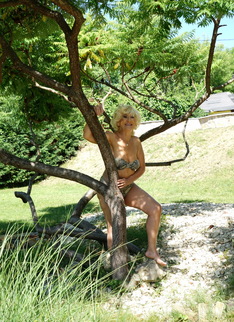 Horny blonde mature woman getting naughty in her garden