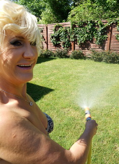 Horny blonde mature woman getting naughty in her garden